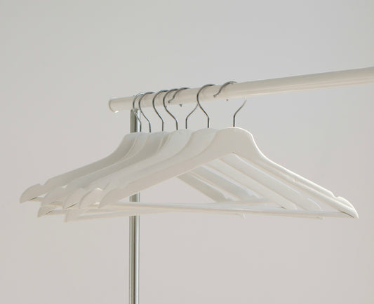 White coathangers on a rack 